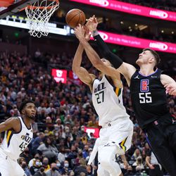 Utah Jazz center Rudy Gobert (27) and LA Clippers center Isaiah Hartenstein (55) go for a rebound during the game at Vivint Arena in Salt Lake City on Wednesday, Dec. 15, 2021.
