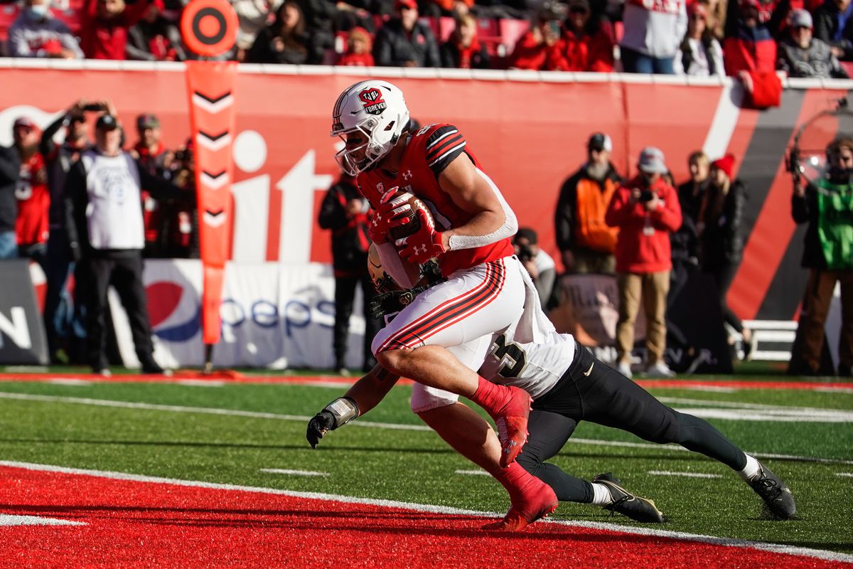 Utah tight end Brant Kuithe, wearing red, crosses the goal line