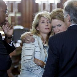 Sen. Wendy Davis, D-Fort Worth, second from left, is hugged by Sen. Sylvia Garcia, D-Houston, as she prepares to filibuster an abortion bill, Tuesday, June 25, 2013, in Austin, Texas. The bill would ban abortion after 20 weeks of pregnancy and force many clinics that perform the procedure to upgrade their facilities and be classified as ambulatory surgical centers. With Davis is Sen. Rodney Ellis, left, and Sen. Kirk Watson, D-Austin, right. (AP Photo/Eric Gay)
