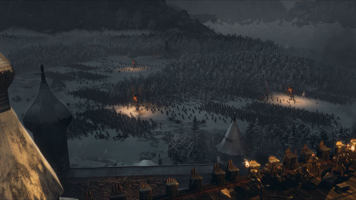 A view of Mother Ostankya’s army from a distance at night, as Kossars watch her approach from the ramparts of a Kislevite city in Total War: Warhammer 3 Shadows of Change