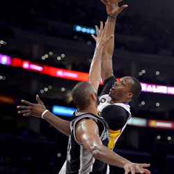 Los Angeles Lakers center Dwight Howard, right, shoots as San Antonio Spurs forward Tim Duncan defends during the first half in Game 4 of a first-round NBA basketball playoff series, Sunday, April 28, 2013, in Los Angeles. 