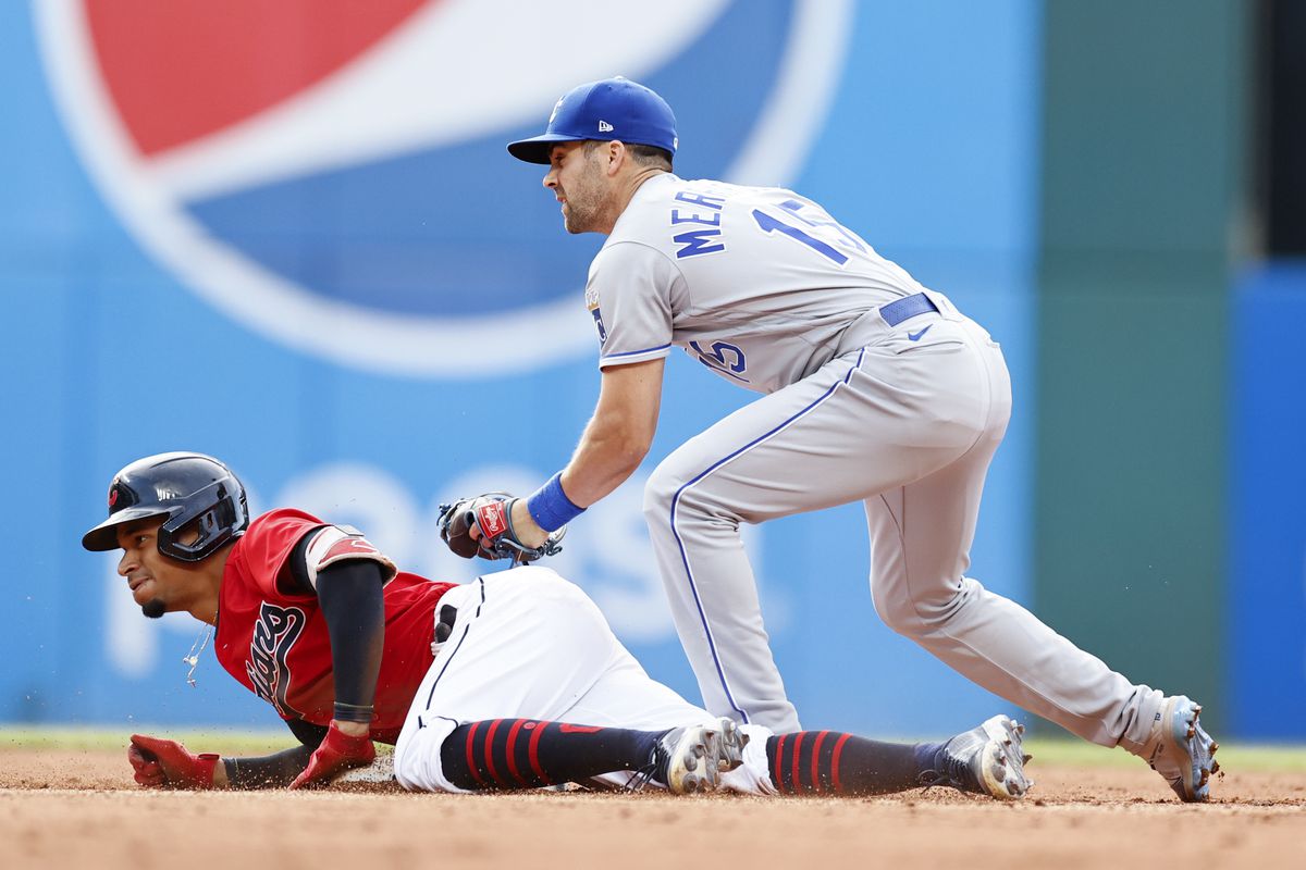 Oscar Mercado #35 of the Cleveland Indians is safe at second base after hitting an RBI single and advancing on an error as Whit Merrifield #15 of the Kansas City Royals covers during the fourth inning at Progressive Field on July 10, 2021 in Cleveland, Ohio.