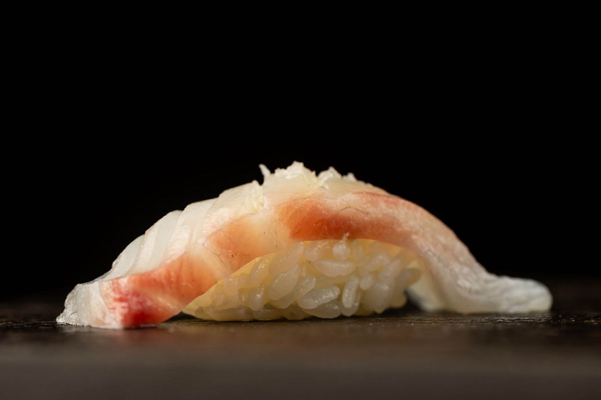 A nigiri course on a black background at Sushi Note Omakase.