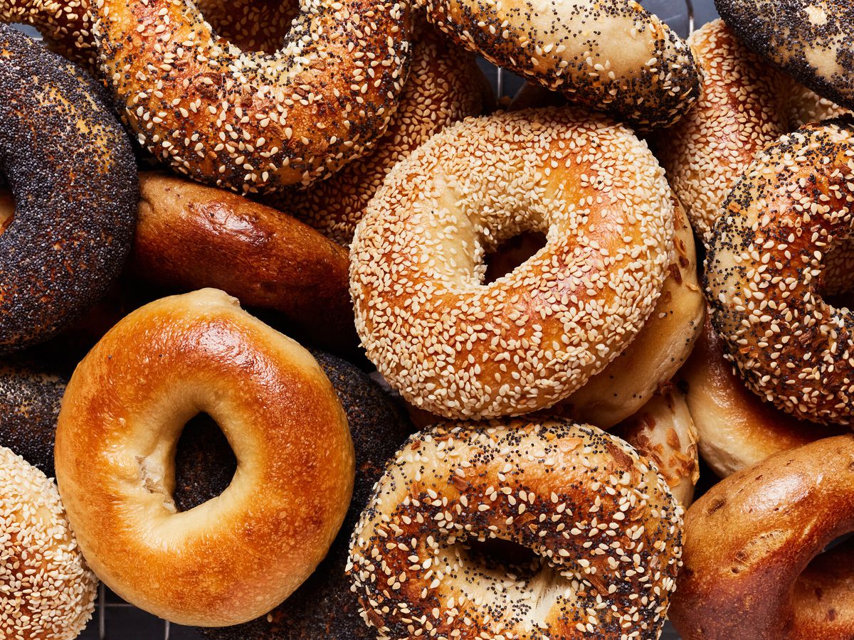 A bunch of differently topped bagels. 