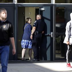 Parents and students enter and exit Mountain View High School in Orem on Tuesday, Nov. 15, 2016, after five students were stabbed in an apparent attack by a 16-year-old boy.