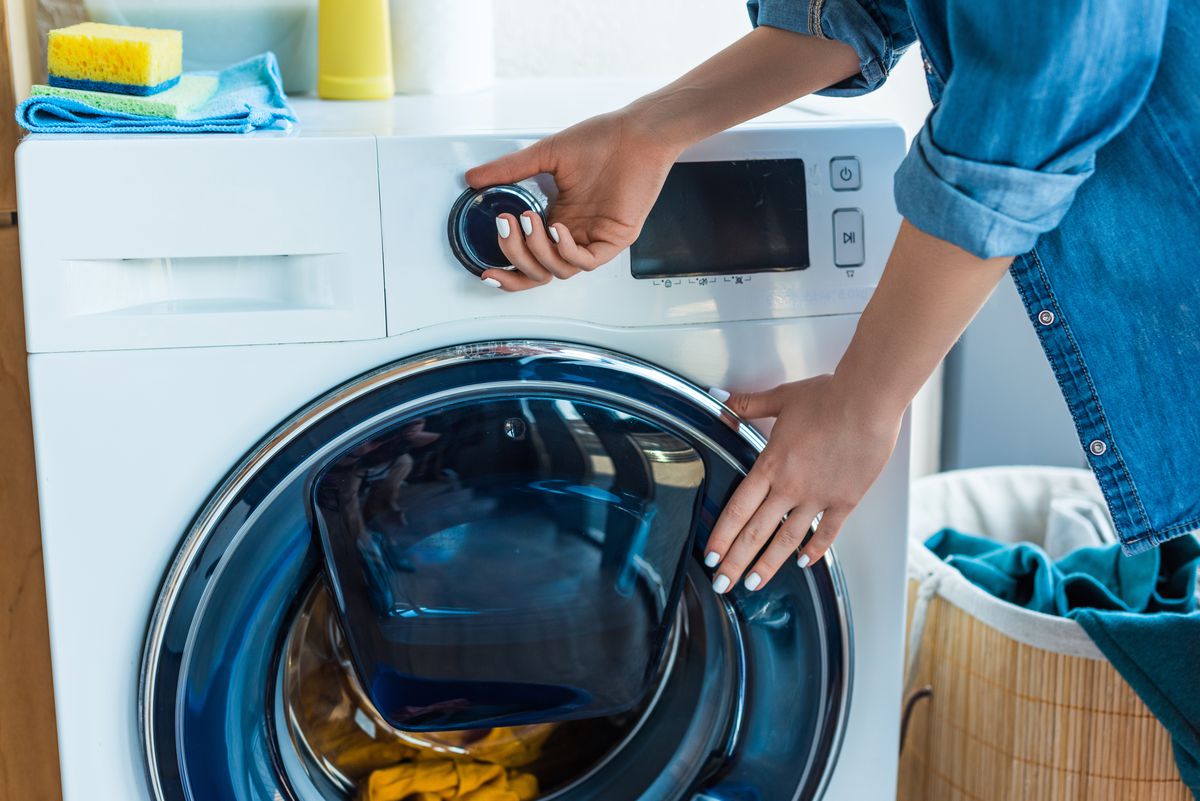 Picture of a woman and a washing machine