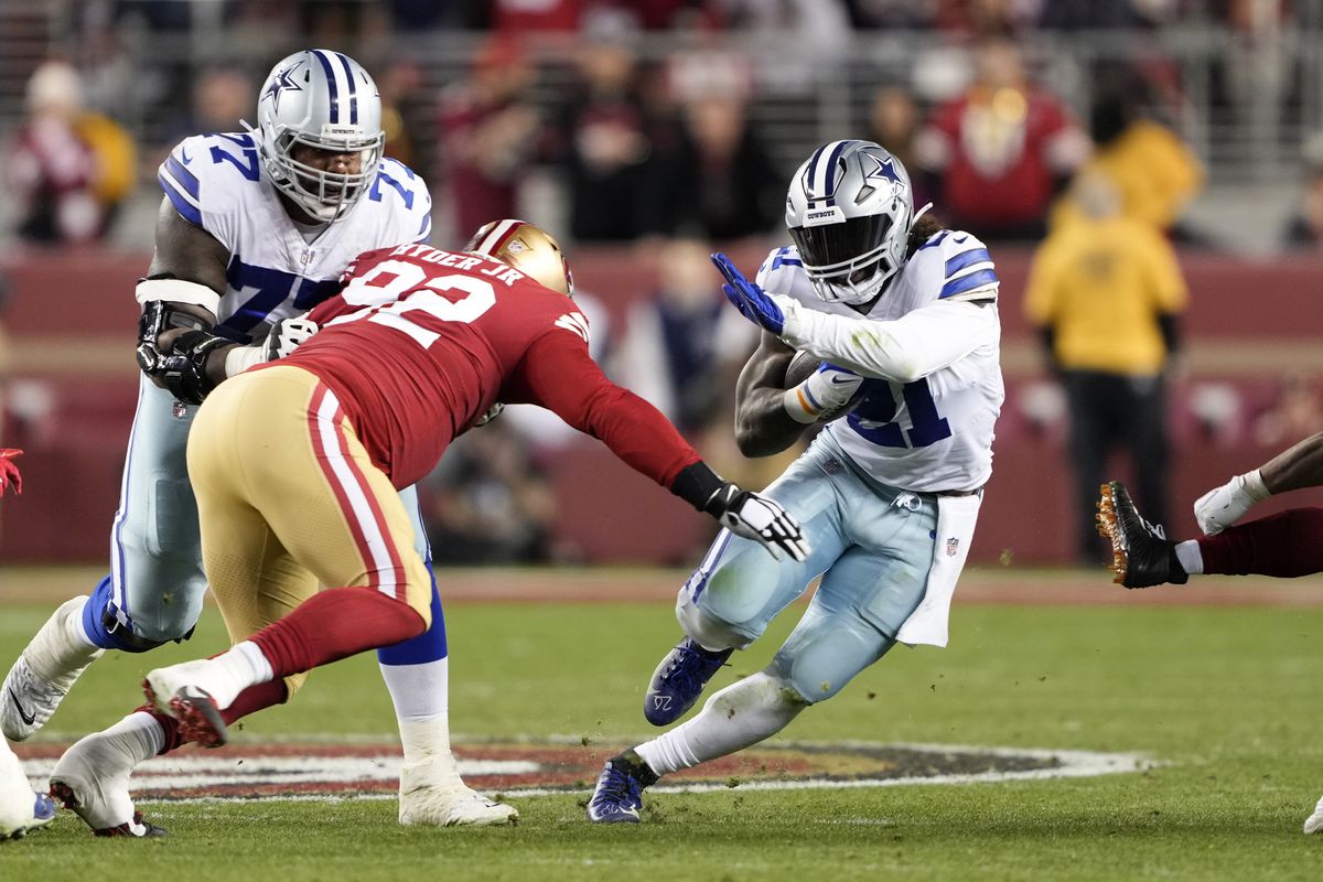 Ezekiel Elliott of the Dallas Cowboys carries the ball against the San Francisco 49ers during the second half in the NFC Divisional Playoff game at Levi’s Stadium on January 22, 2023 in Santa Clara, California.