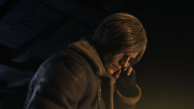 Leon S Kennedy taps his ear to listen to a comms call in Resident Evil 4 remake