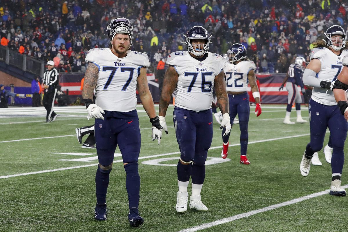 Tennessee Titans tackle Taylor Lewan (77) and Tennessee Titans guard Rodger Saffold III (76) walk off the field during an AFC Wild Card game between the New England Patriots and the Tennessee Titans on January 4, 2020, at Gillette Stadium in Foxborough, Massachusetts.