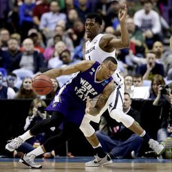 Weber State's Joel Bolomboy (21) moves the ball past Xavier's Jalen Reynolds (1) during the first half of a first-round men's college basketball game in the NCAA Tournament, Friday, March 18, 2016, in St. Louis. (AP Photo/Charlie Riedel)