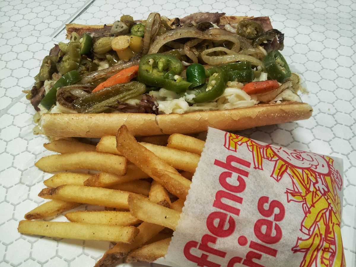 An Italian beef with fries.