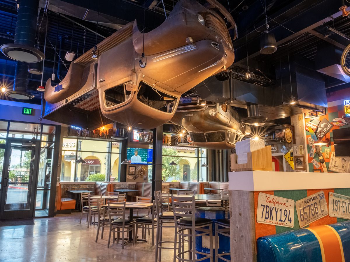A truck hangs from the ceiling of a restaurant