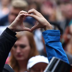 Ashleigh Matherly and Arlin Cooper make a heart with their hands during a vigil for the victims and survivors of the mass shooting at a gay nightclub in Orlando, Florida, outside of the Salt Lake City-County Building on Monday, June 13, 2016.