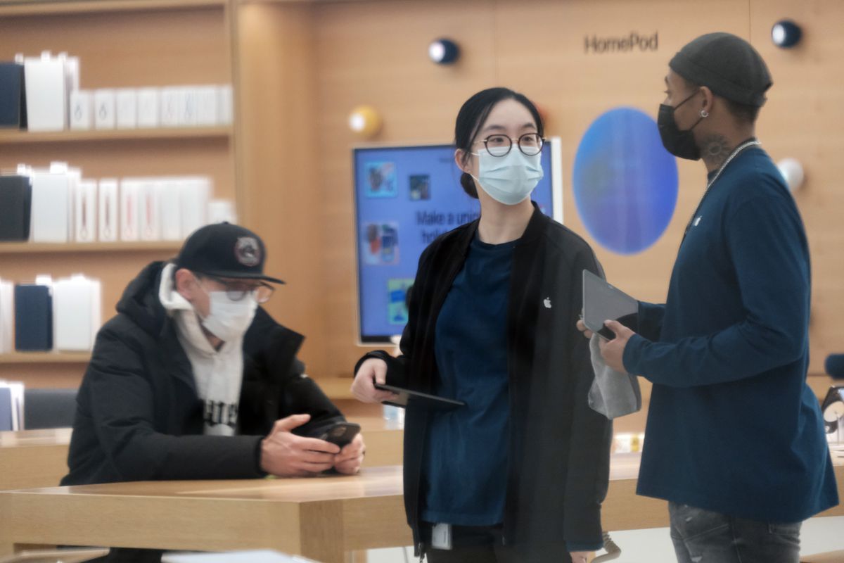 People at an Apple store wear masks in The Oculus in lower Manhattan on the day that a mask mandate took effect in New York on Dec. 13, 2021.
