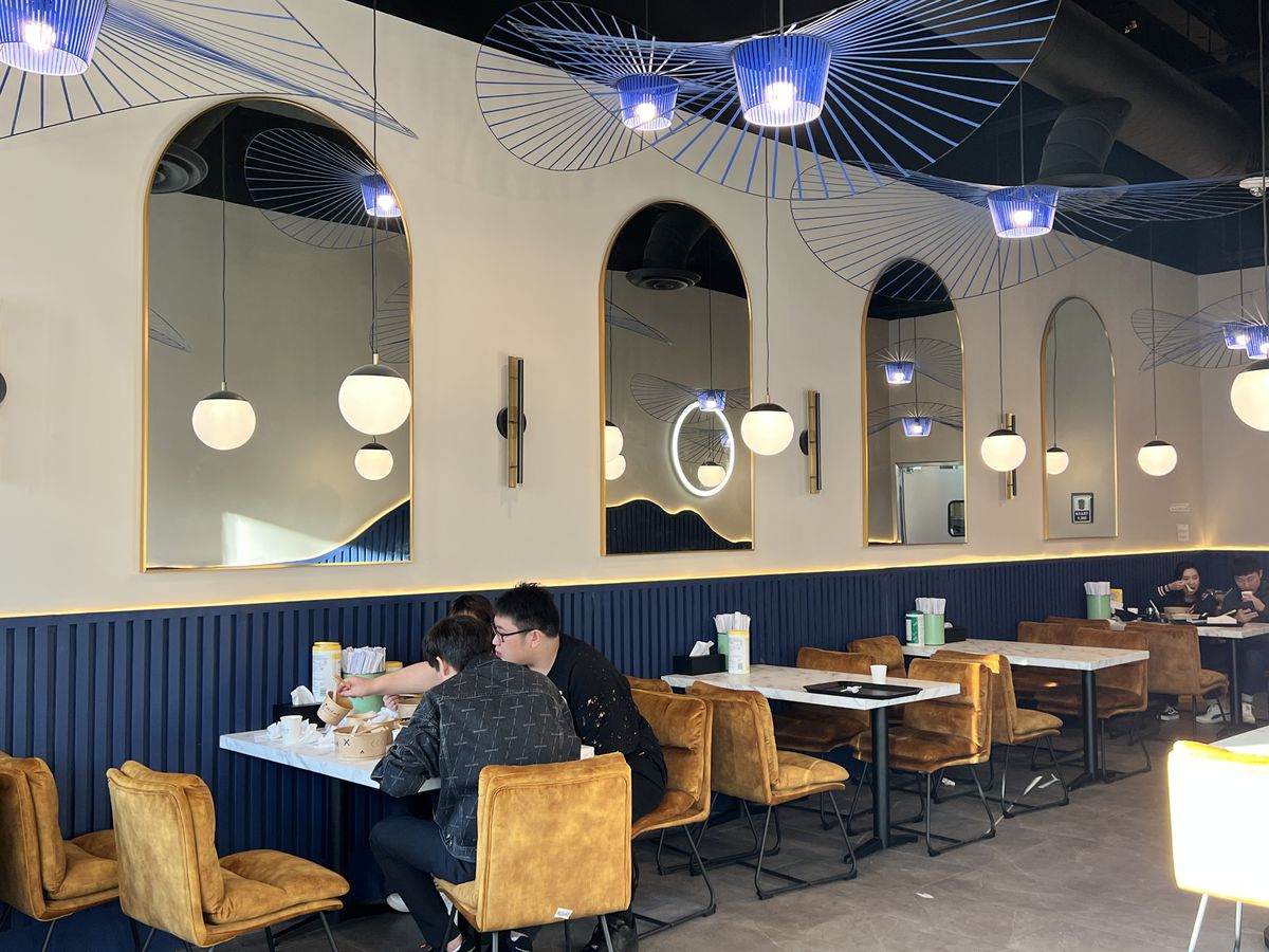 People eating inside a modern restaurant.