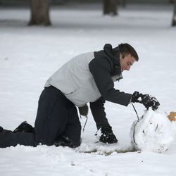 Talmage Sanders builds a ball to make a snowman in Liberty Park after a fast-moving snowstorm hit the Salt Lake Valley on Wednesday, Dec. 12, 2018.