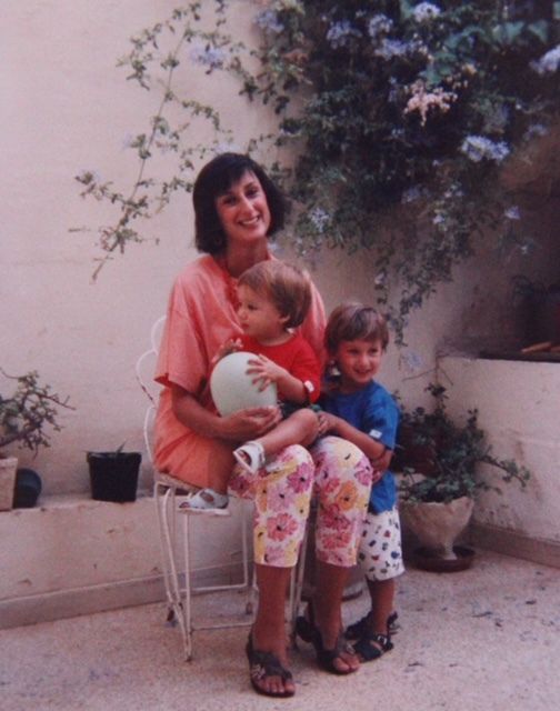 Daphne Caruana Galizia holding two young children on her lap.