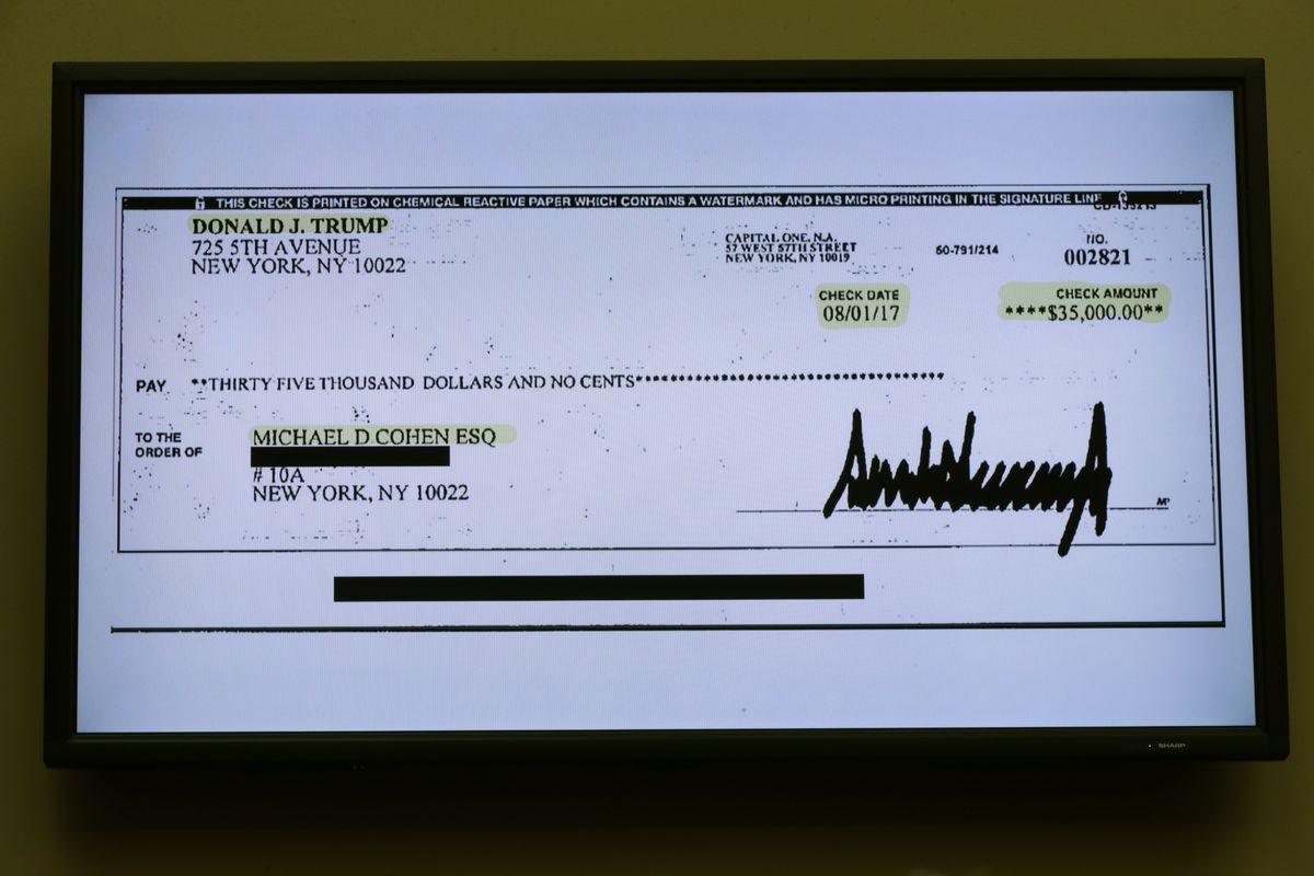 A copy of a check paid to Michael Cohen by President Donald Trump displayed at a House Oversight Committee hearing in February 2019.