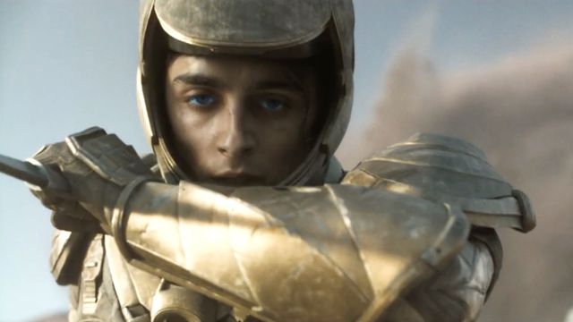 a close-up of Paul (Timothee Chalamet) wearing gold armor in Dune