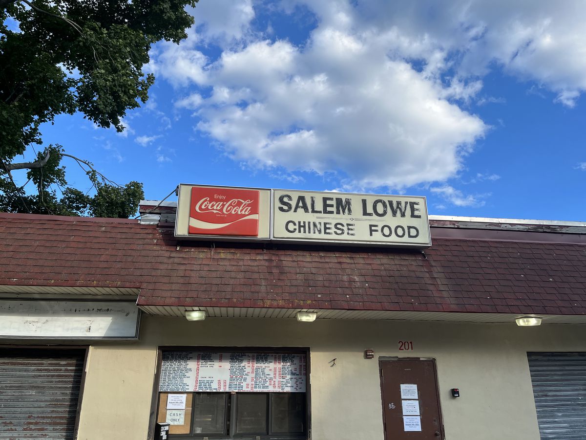 An old-looking restaurant exterior has a takeout window, menu board, and old signage with Coke branding reading Salem Lowe Chinese food.