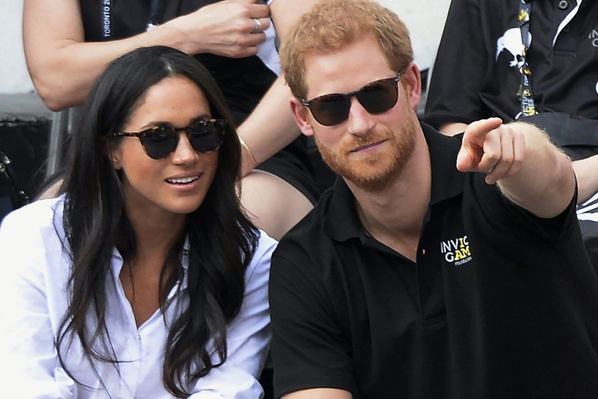 FILE - In this Monday, Sept. 25, 2017 file photo, Britain's Prince Harry and his girlfriend Meghan Markle attend the wheelchair tennis competition during the Invictus Games in Toronto. Palace officials announced Monday Nov. 27, 2017, Prince Harry and Megh