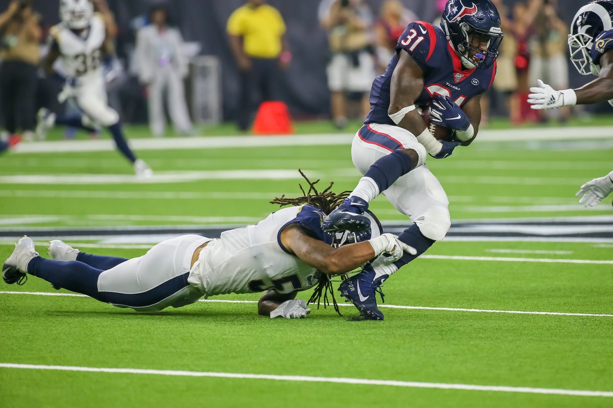 Los Angeles Rams LB Dakota Allen tackles Houston Texans RB Karan Higdon in a preseason game, Aug. 29, 2019.