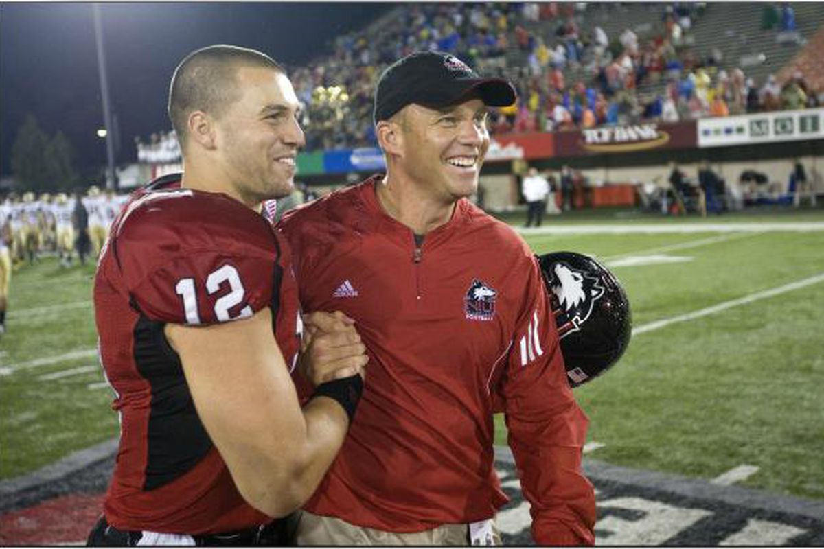 Chandler Harnish and new head coach Dave Doeren celebrate at midfield after the team's first victory of the season.  ~NIU Athletics