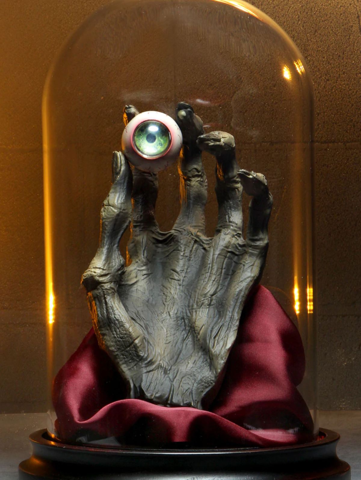 A glass case conceals the hand and eye of Vecna.