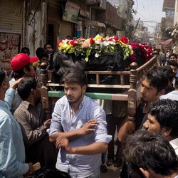 People prepare to burry the body of Christian man killed in bomb attack in Lahore, Pakistan, Monday, March 28, 2016. The death toll from a massive suicide bombing targeting Christians gathered on Easter in the eastern Pakistani city of Lahore rose on Monday as the country started observing a three-day mourning period following the attack. 