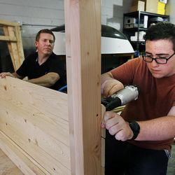 Student Josh Lefler attaches a board while building a playhouse at American Fork High School in American Fork on Thursday, Nov. 10, 2016. The playhouse, built by AFHS and Oakwood Homes, will be sold at the Festival of Trees. Behind Josh is wood shop teacher Sandon Ellefson.