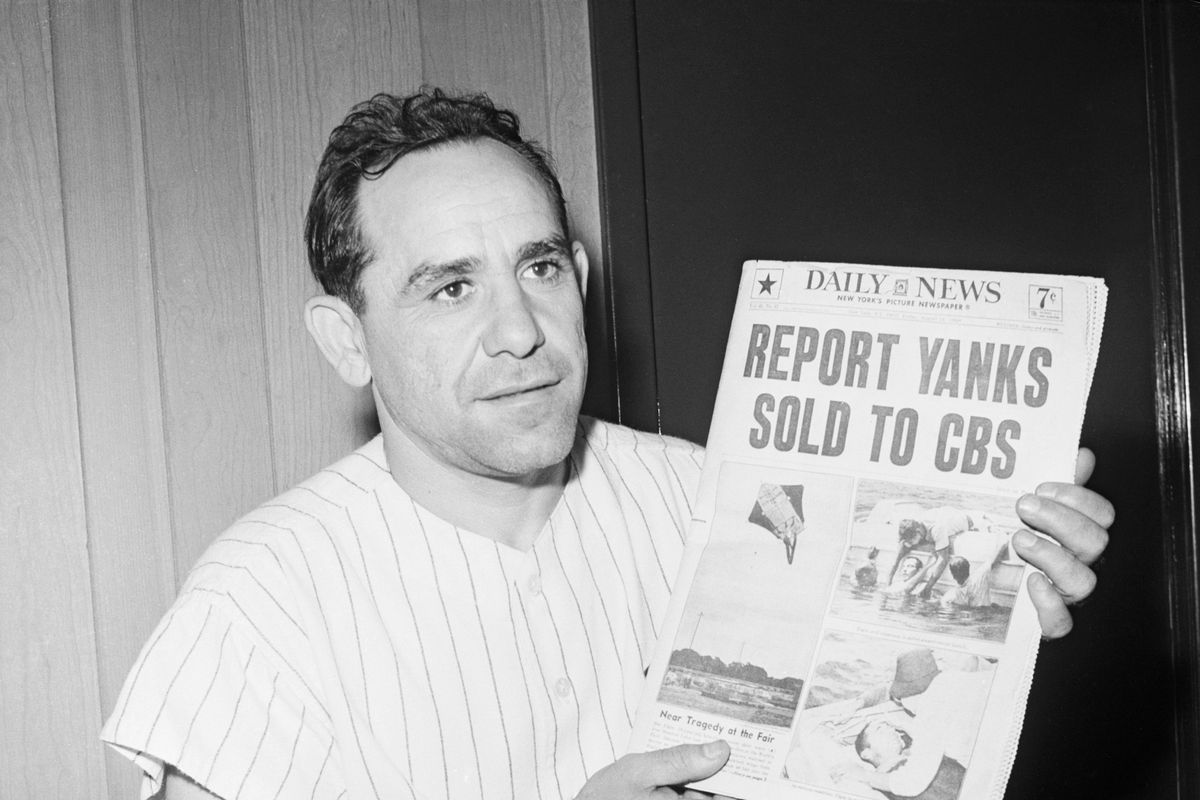 Yogi Berra Holds Newspaper