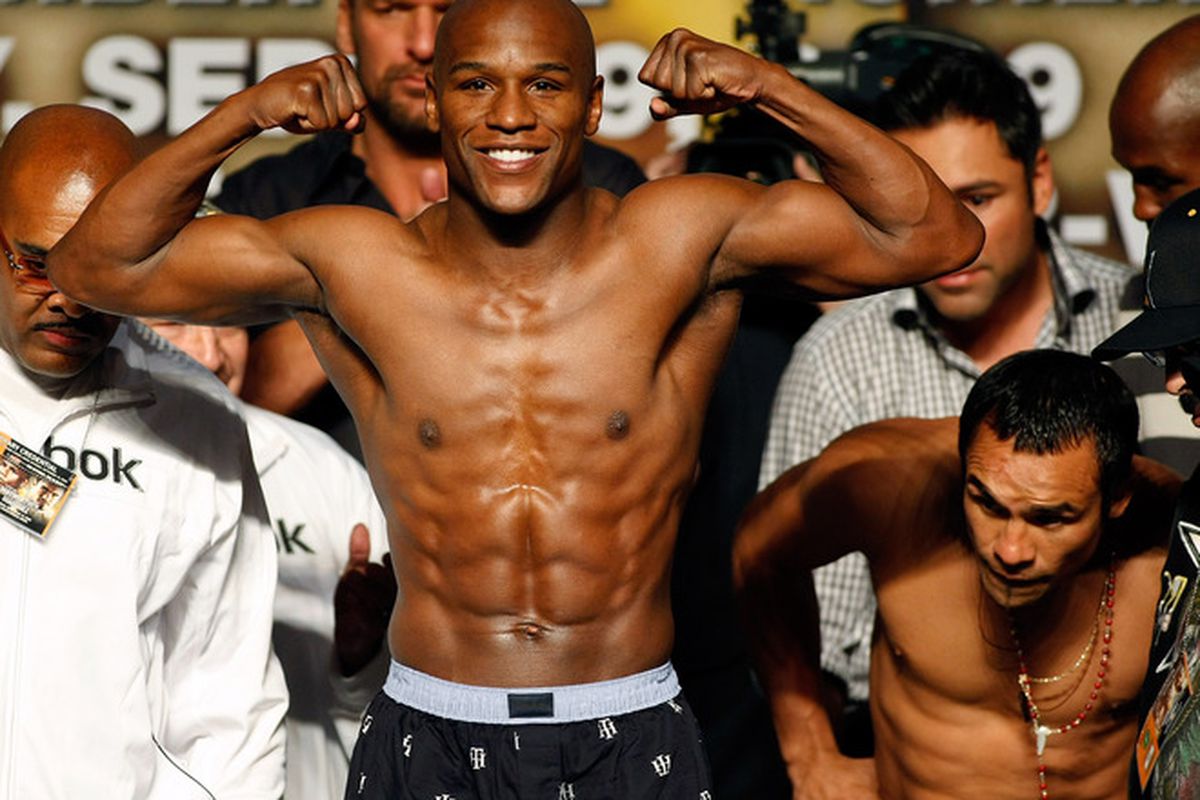 Floyd Mayweather Jr. weighs in while Juan Manuel Marquez looks at the scale. We now know that Marquez was seeing just how much money was being tacked on to his paycheck tomorrow. (Photo by Ethan Miller/Getty Images)
