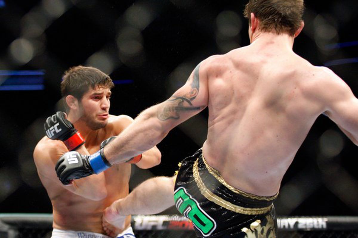 MONTREAL- MAY 8: Alan Belcher (R) kicks Patrick Cote in the stomach in their middleweight bout at UFC 113 at Bell Centre on May 8, 2010 in Montreal, Quebec, Canada.  (Photo by Richard Wolowicz/Getty Images)
