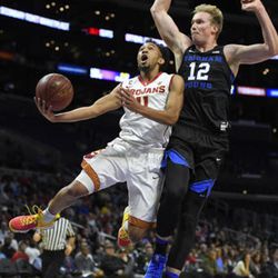 Southern California guard Jordan McLaughlin, left, shoots as BYU forward Eric Mika defends during the first half of an NCAA college basketball game, Saturday, Dec. 3, 2016, in Los Angeles. (AP Photo/Mark J. Terrill)