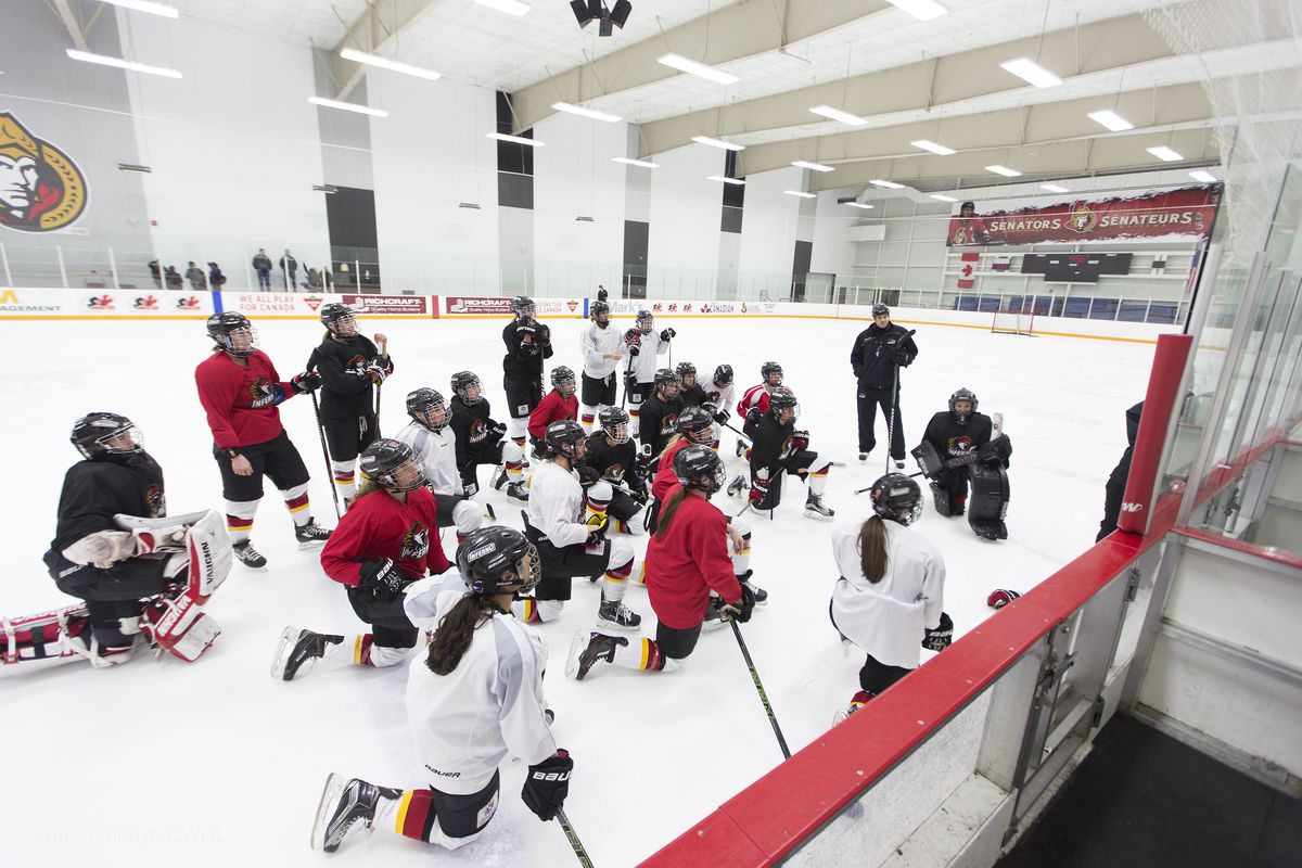 The Calgary Inferno look on as head coach Scott Reid outlines a drill for the final practice before the Clarkson Cup Final in Ottawa Sunday. 