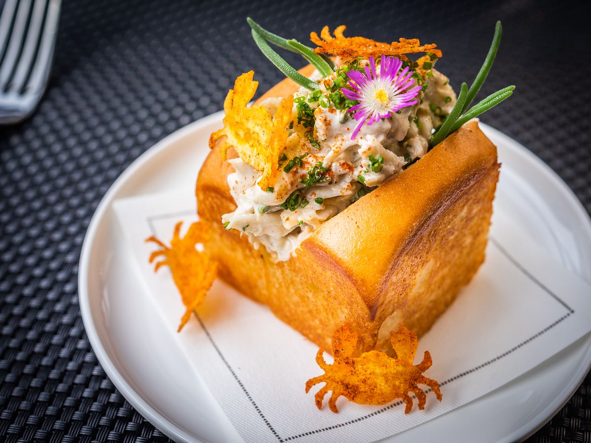 Estuary crab roll, with bread crab-shaped garnishes and edible flowers