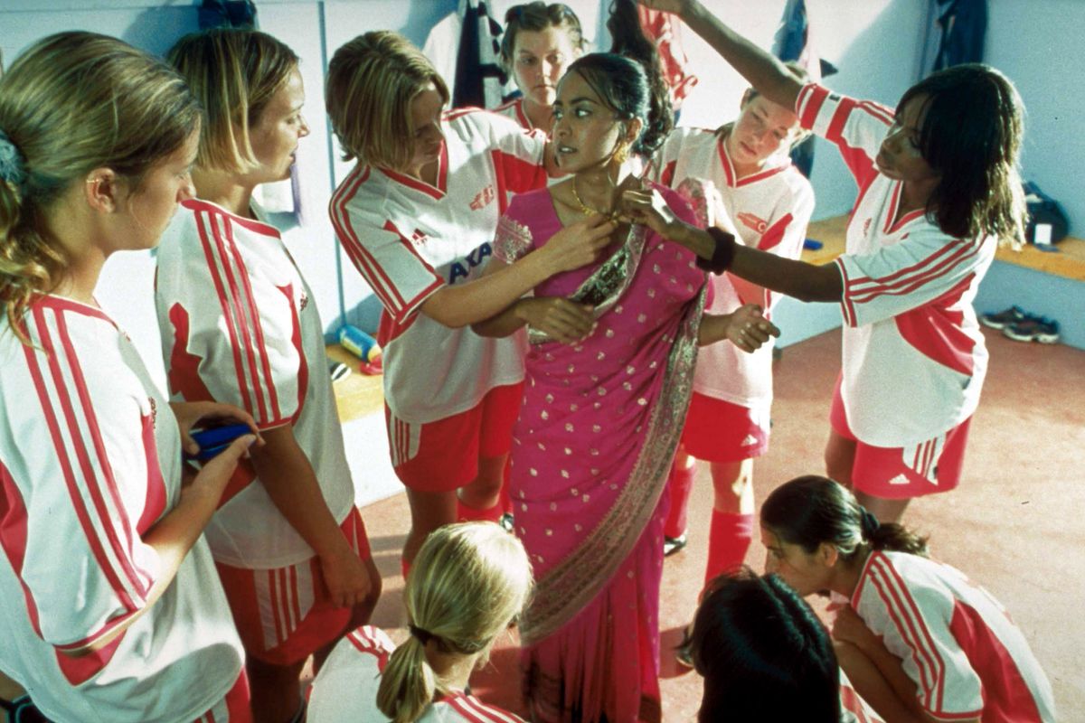 Still frame from the movie ‘Bend it like Beckham’ in which the main character wears a sari while garnering attention from her soccer teammates in the locker room.
