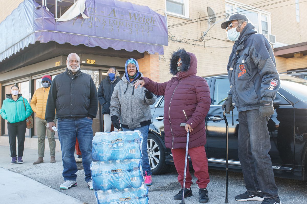 Tenants of the apartment building at 1413 E. 79th St., including Erwin Johnson (from left), Theressie Johnson and Margaret Jackson, held a news conference in front of the building on Tuesday. Just two days before Thanksgiving, they feel compelled to move after their landlord shut off heat and water in the building.