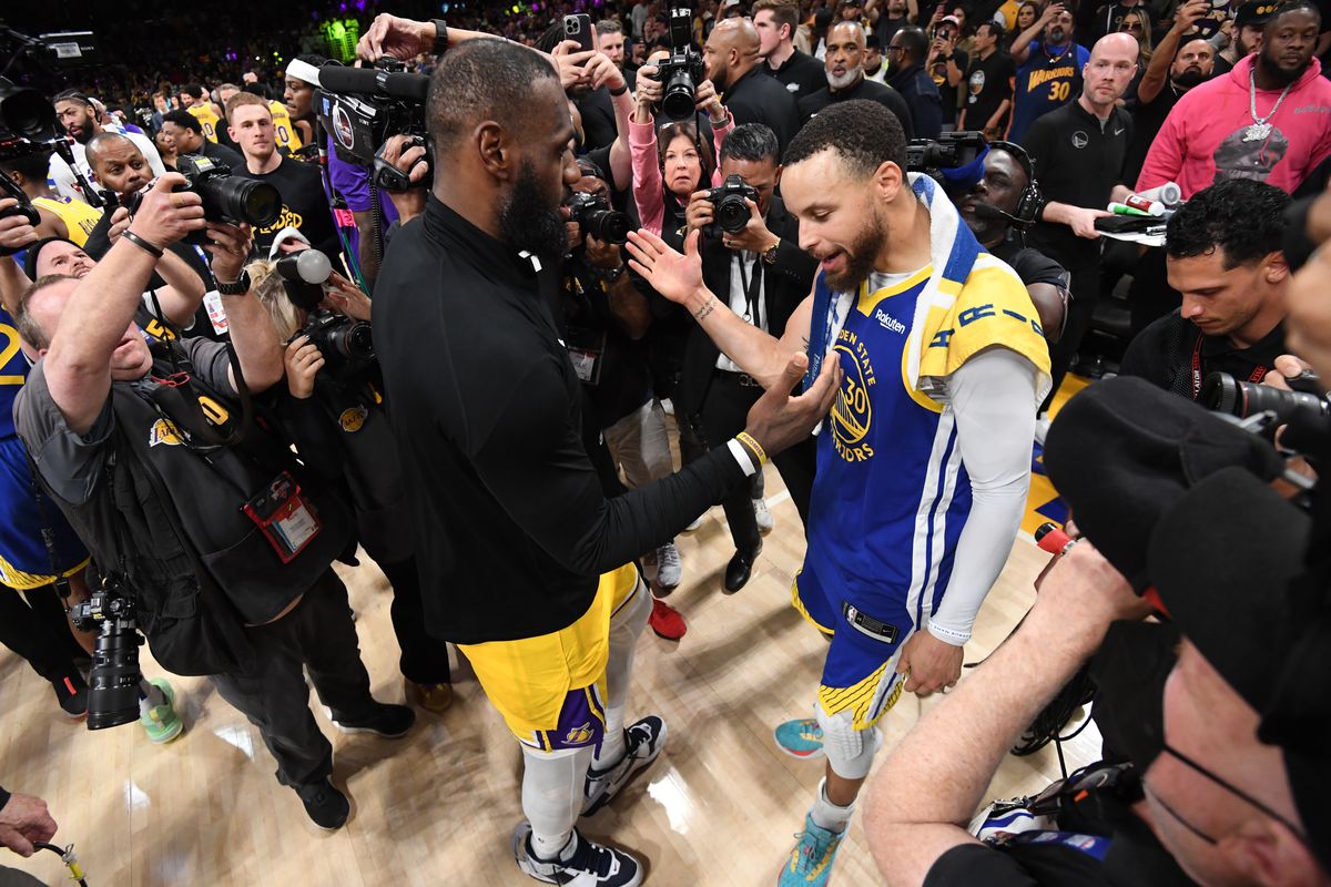 Steph Curry reaching out to embrace LeBron James after a loss