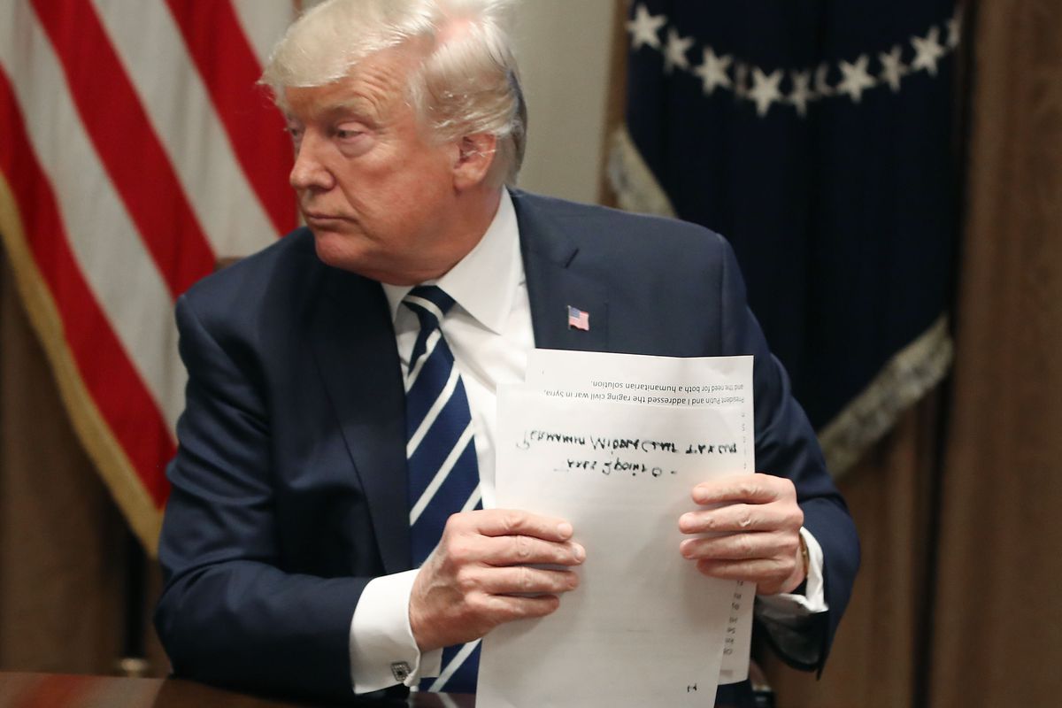 U.S. President Donald Trump holding papers