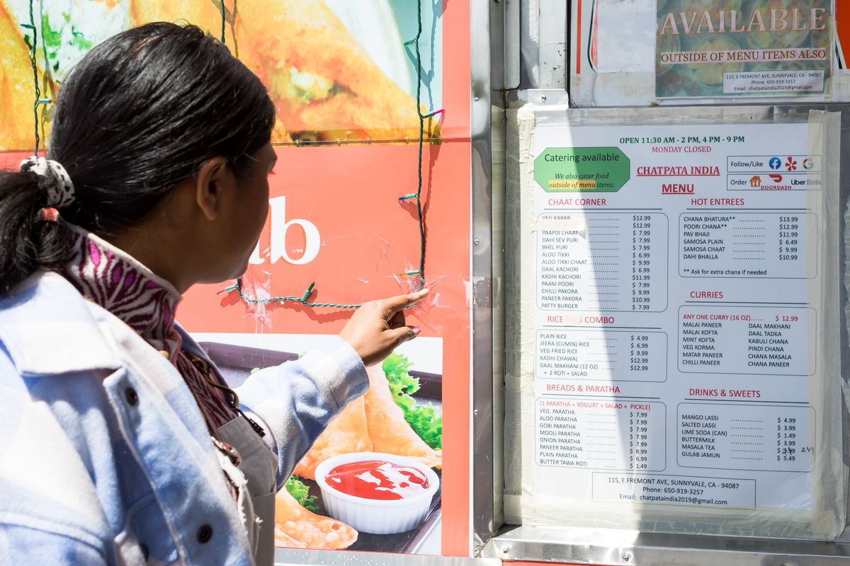 Hetal Vasavada looks at a food truck menu.