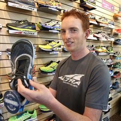Golden Harper poses with an Altra shoe. The Utahn created Altra, a shoe company, in hopes of delivering shoes that were more natural.