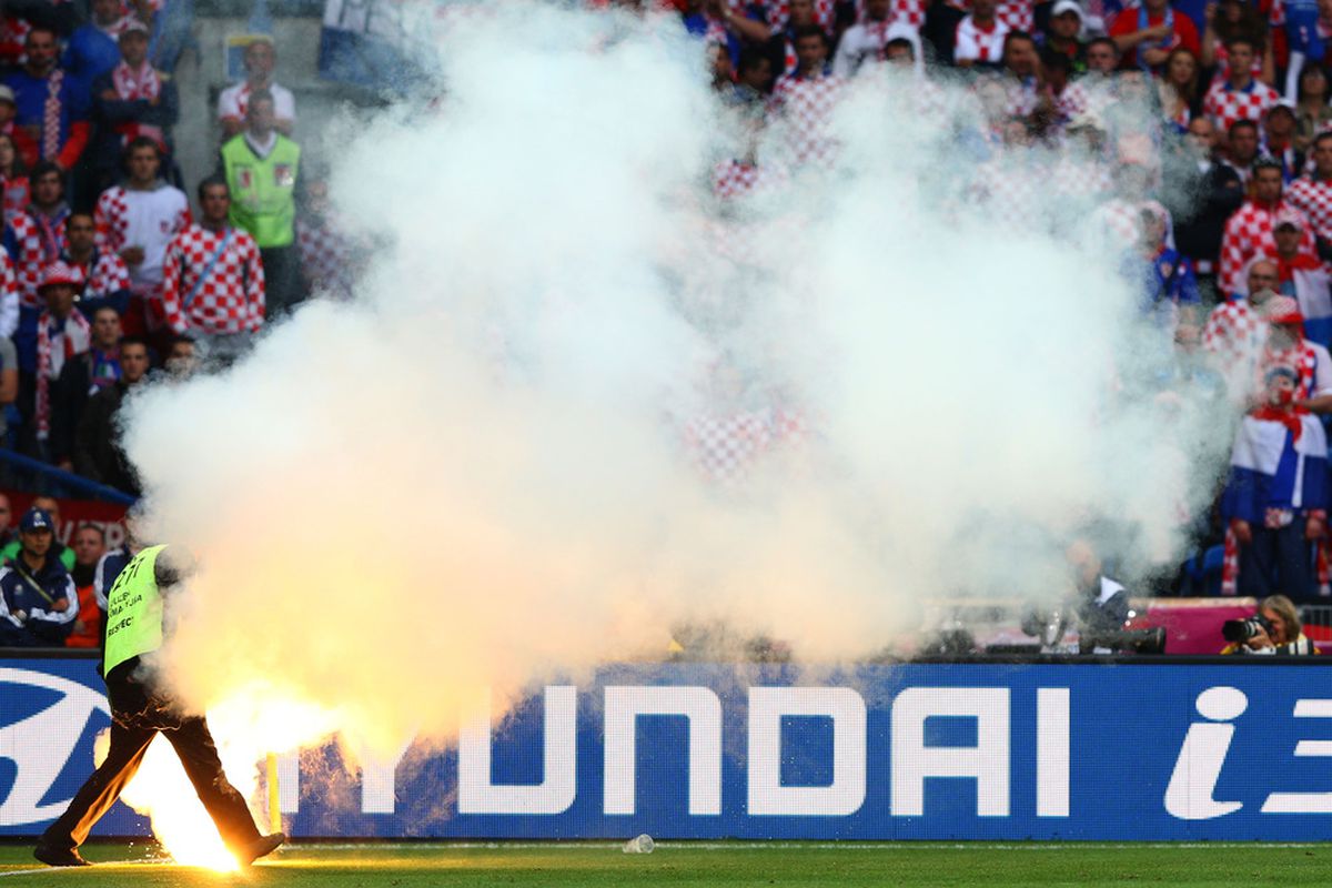 POZNAN, POLAND - JUNE 14:  Croatian fans look on as a flare burns on the field during the UEFA EURO 2012 group C match between Italy and Croatia at The Municipal Stadium on June 14, 2012 in Poznan, Poland.  (Photo by Clive Mason/Getty Images)