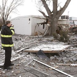 Members of the State Fire Marshal's office probe the rubble of a Pleasant Grove home.