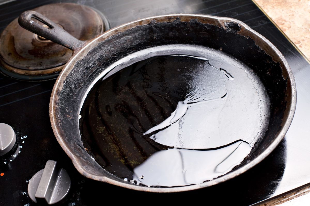 Cast iron skillet with hot oil in the pan. 