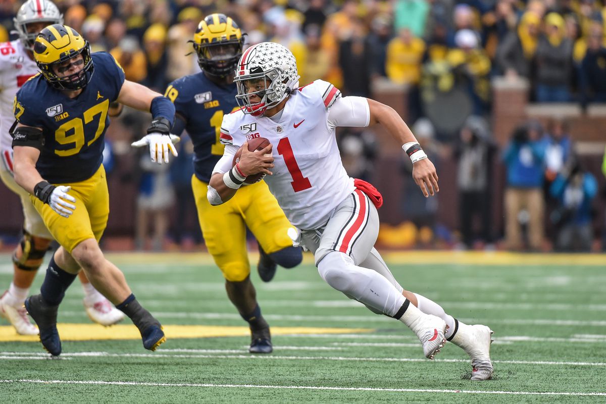 Quarterback Justin Fields of the Ohio State Buckeyes runs during the first half of a college football game against the Michigan Wolverines at Michigan Stadium on November 30, 2019 in Ann Arbor, MI.