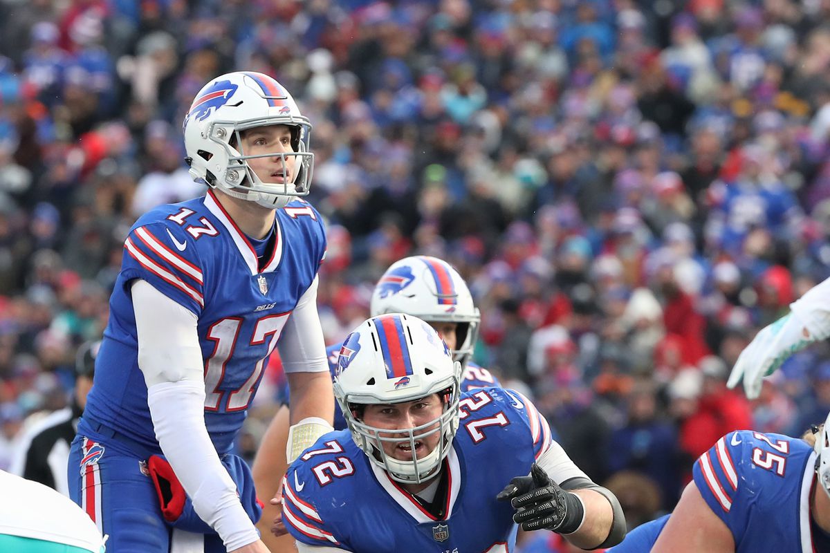 Josh Allen of the Buffalo Bills waits for the snap as Ryan Groy calls out instructions in the third quarter during NFL game action against the Miami Dolphins at New Era Field on December 30, 2018 in Buffalo, New York.