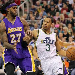 Utah Jazz guard Trey Burke (3) tries to drive past Los Angeles Lakers center Jordan Hill (27) as the Jazz and the Lakers play Wednesday, Feb. 25, 2015, at EnergySolutions Arena in Salt Lake City.