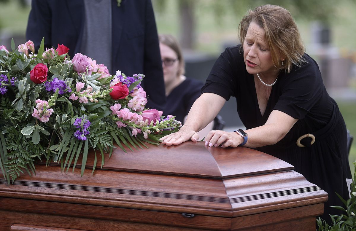 Tricia Wright grieves over the casket of her sister, Shawna Wright, who died of heat exhaustion while homeless, during Shawna Wright’s interment at Mount Olivet Cemetery in Salt Lake City on Tuesday, July 13, 2021.