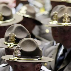 Troopers move to line the way for Utah Highway Patrol trooper Eric Ellsworth's casket during funeral services at the Dee Events Center in Ogden on Wednesday, Nov. 30, 2016.